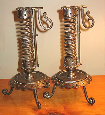 PAIR OF IRON PIGTAIL CANDLESTICKS