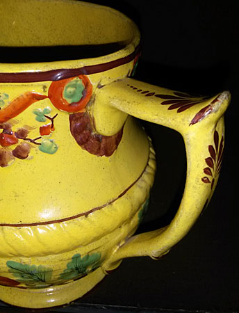 SOLD Yellow-glazed jug with masks