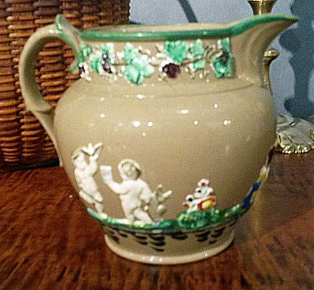 SOLD  Sprigged jug in merry colors.