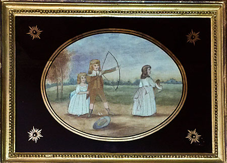 Pair of silk needlework pictures of children playing