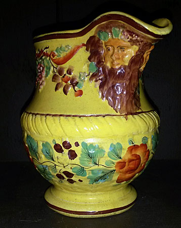 SOLD Yellow-glazed jug with masks